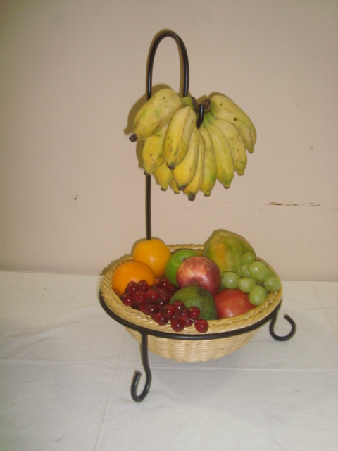 Rattan basket designed to contain fruits with a metal hook to hang bananas